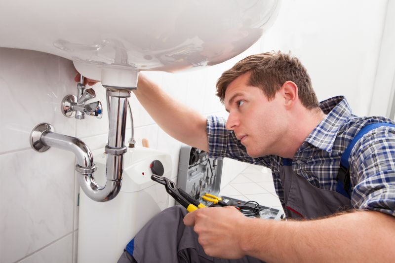 Plumber Repairing Pipe